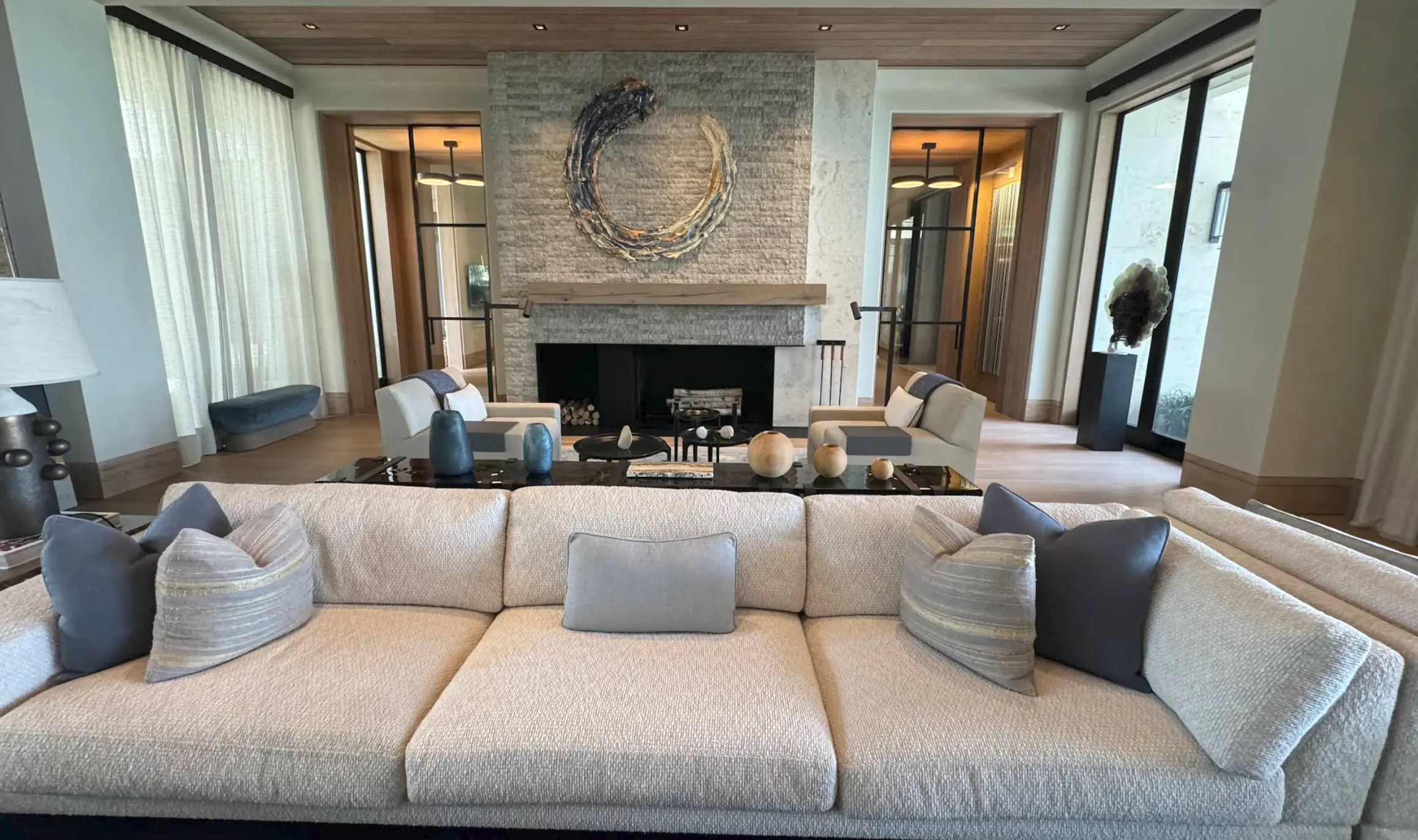 Living room with natural stone fireplace and wood flooring in a Nassau home
